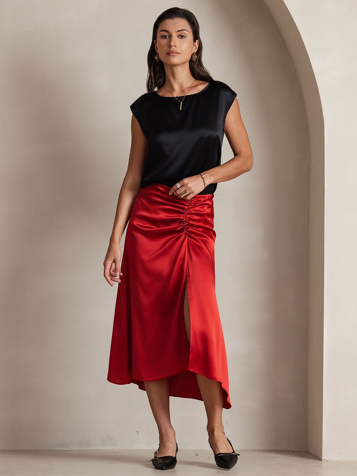 Black satin sleeveless blouse with cap sleeves and round neckline, fluid drape