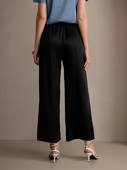 Black wide-leg elastic-waist pants, gathered waistband and relaxed straight legs