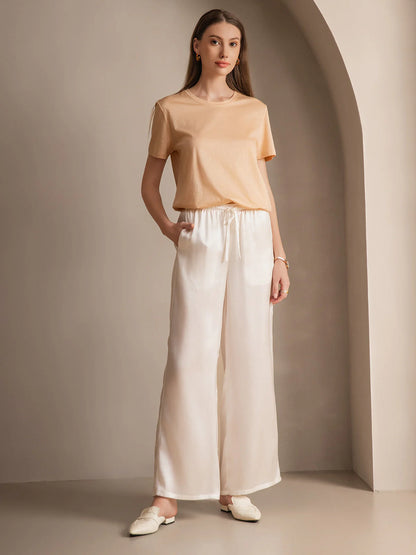 Silk relaxed elastic-waist pants in white, flowing wide-leg silhouette with waist ties