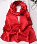 Red satin scarf/shawl draped in a rounded knot, smooth glossy fabric
