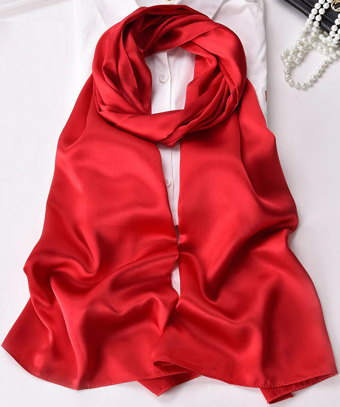 Red satin scarf/shawl draped in a rounded knot, smooth glossy fabric