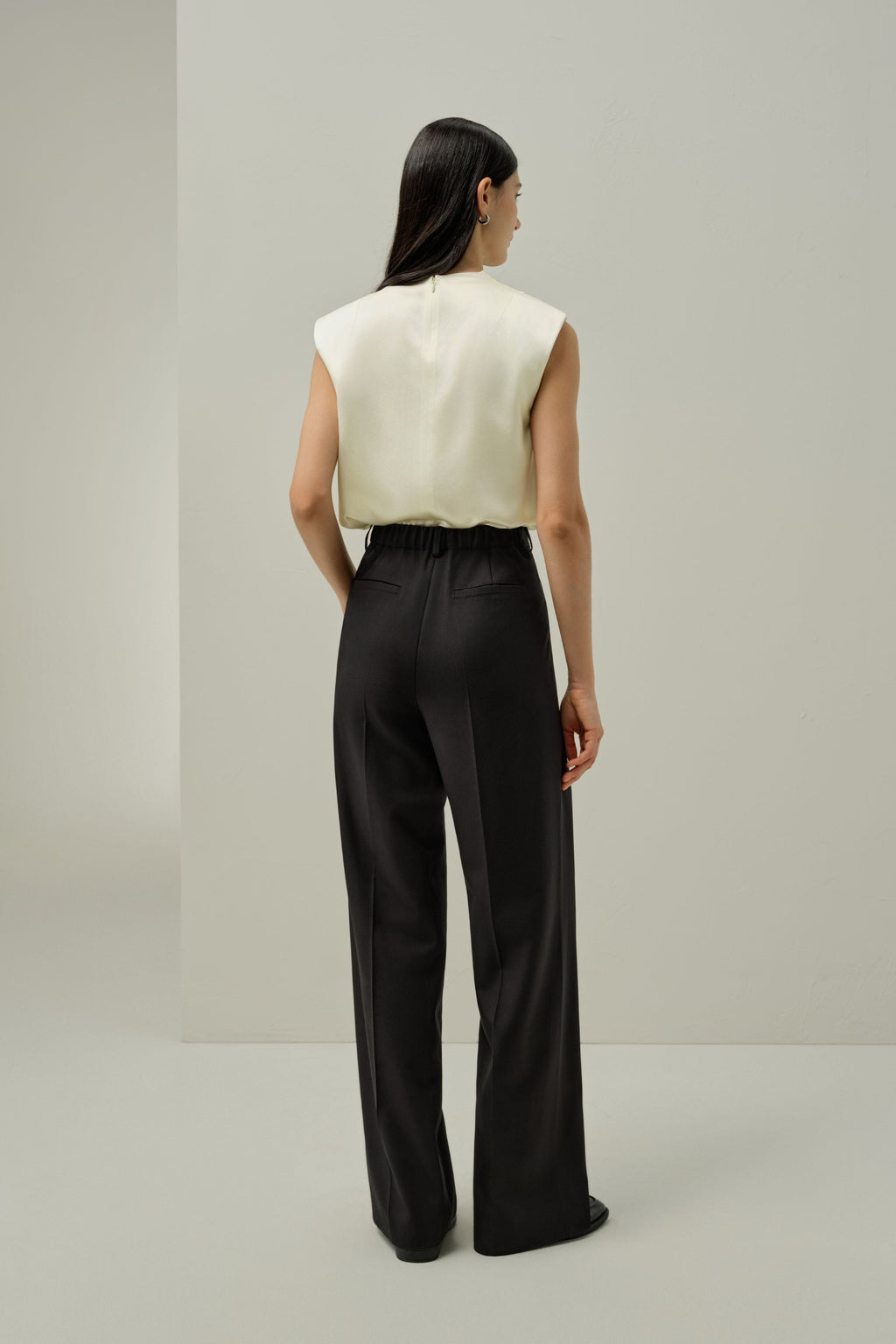 Ivory satin sleeveless blouse, back view with high collar and draped back