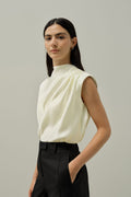 Ivory satin sleeveless blouse with high neckline and soft draped shoulder