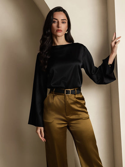 Black satin blouse with wide flare sleeves and round neckline, loose drape.