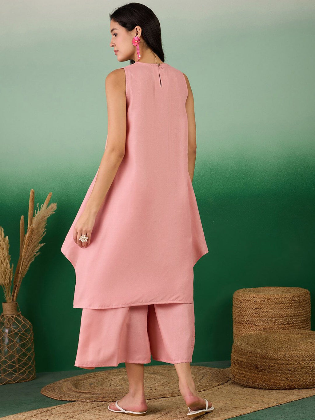 Coral linen sleeveless tunic dress back view with curved hem and midi pants