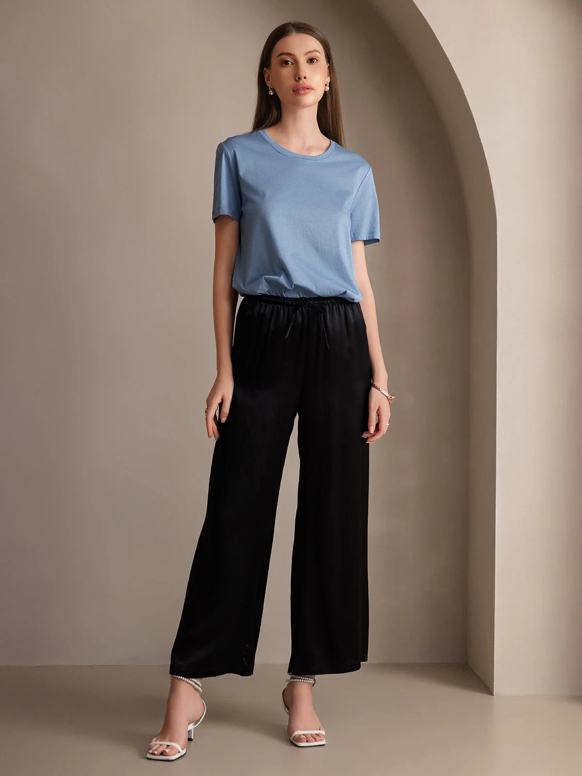 Black wide-leg elastic-waist pants with gathered waistband and relaxed straight legs
