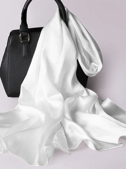 White satin scarf/shawl, draped with silky sheen and flowing ends, one side folded