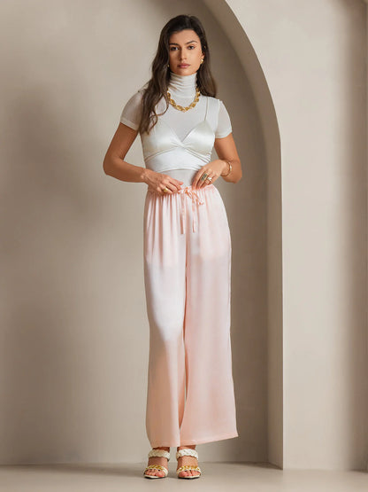 Pink silk wide-leg pants with elastic waist and hanging tie cords
