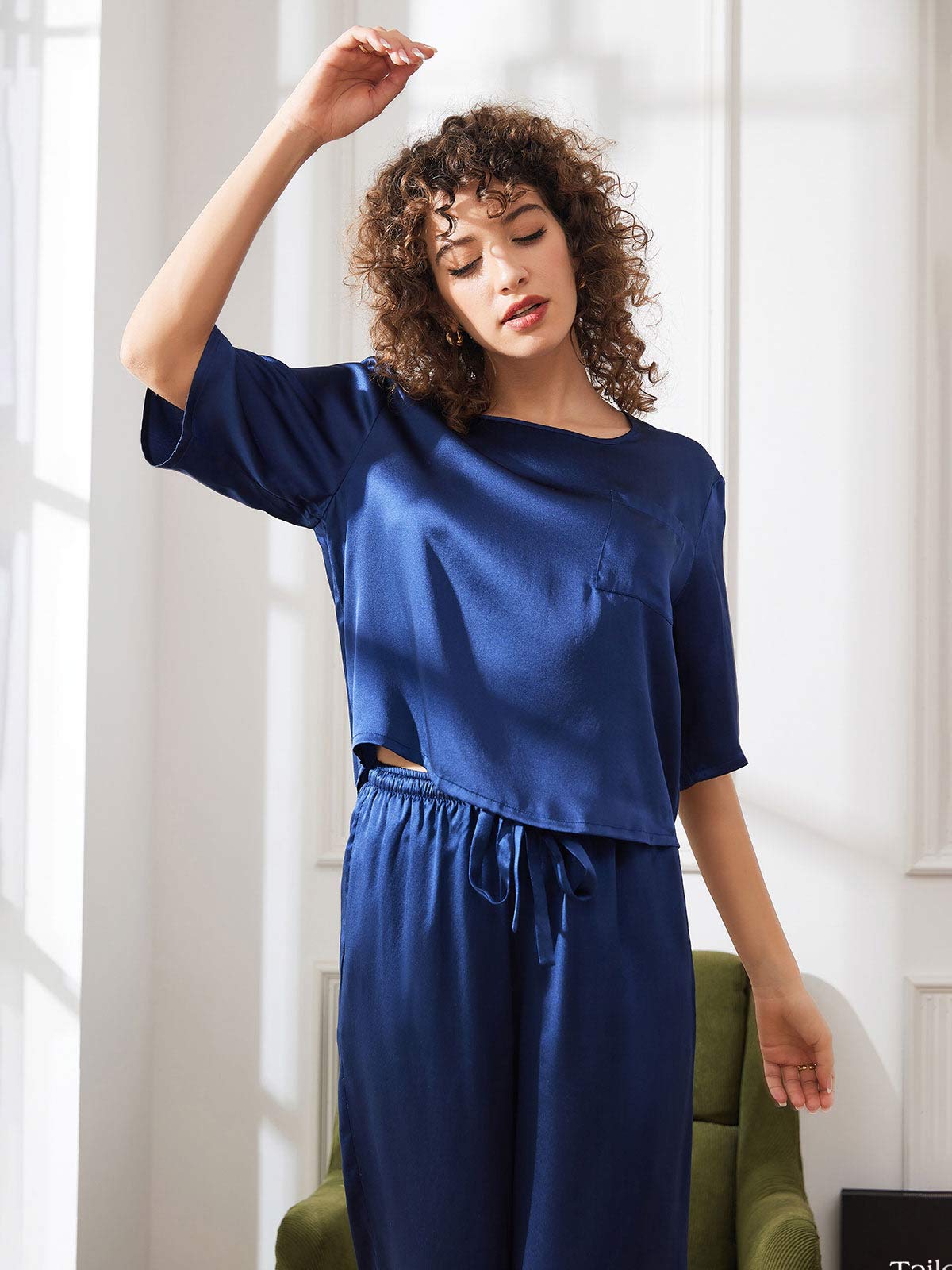 Women’s satin pajama set in dark blue: drapey short-sleeve top with matching drawstring pants