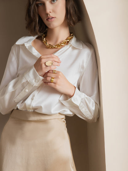 White satin button-down shirt close-up: point collar, button placket, and cuffs