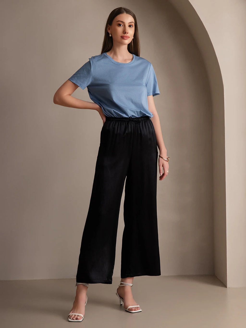 Black wide-leg elastic-waist pants with gathered waist and loose ankle-length legs
