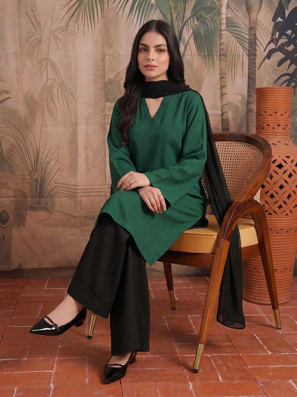 Emerald green V-neck tunic and black wide-leg pants with black neck choker