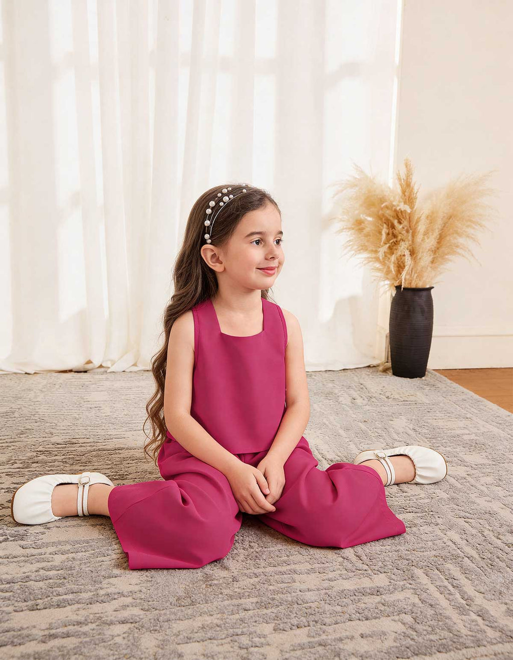 Girls magenta sleeveless square-neck top and wide-leg pants, sitting pose