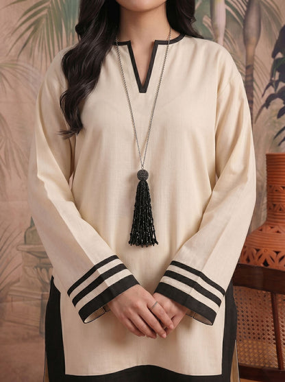 Cream tunic close-up with black V trim, long sleeves, striped cuffs, tassel necklace