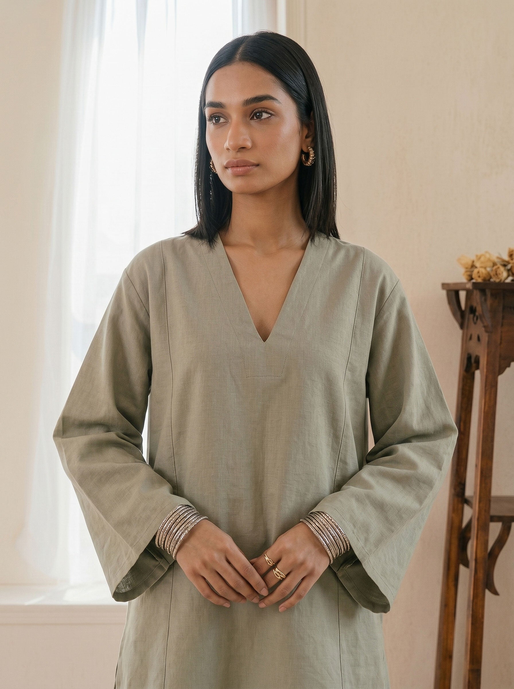 Sage green linen tunic with V-neck, long wide sleeves and relaxed straight cut