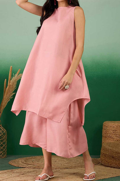 Coral linen sleeveless tunic dress with layered hem, paired with midi pants