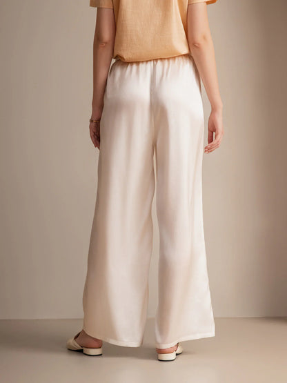 Silk relaxed elastic-waist pants in white with flowing wide legs and gathered waist