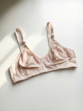Light pink wire-free lace bra with adjustable straps and soft smoothing band