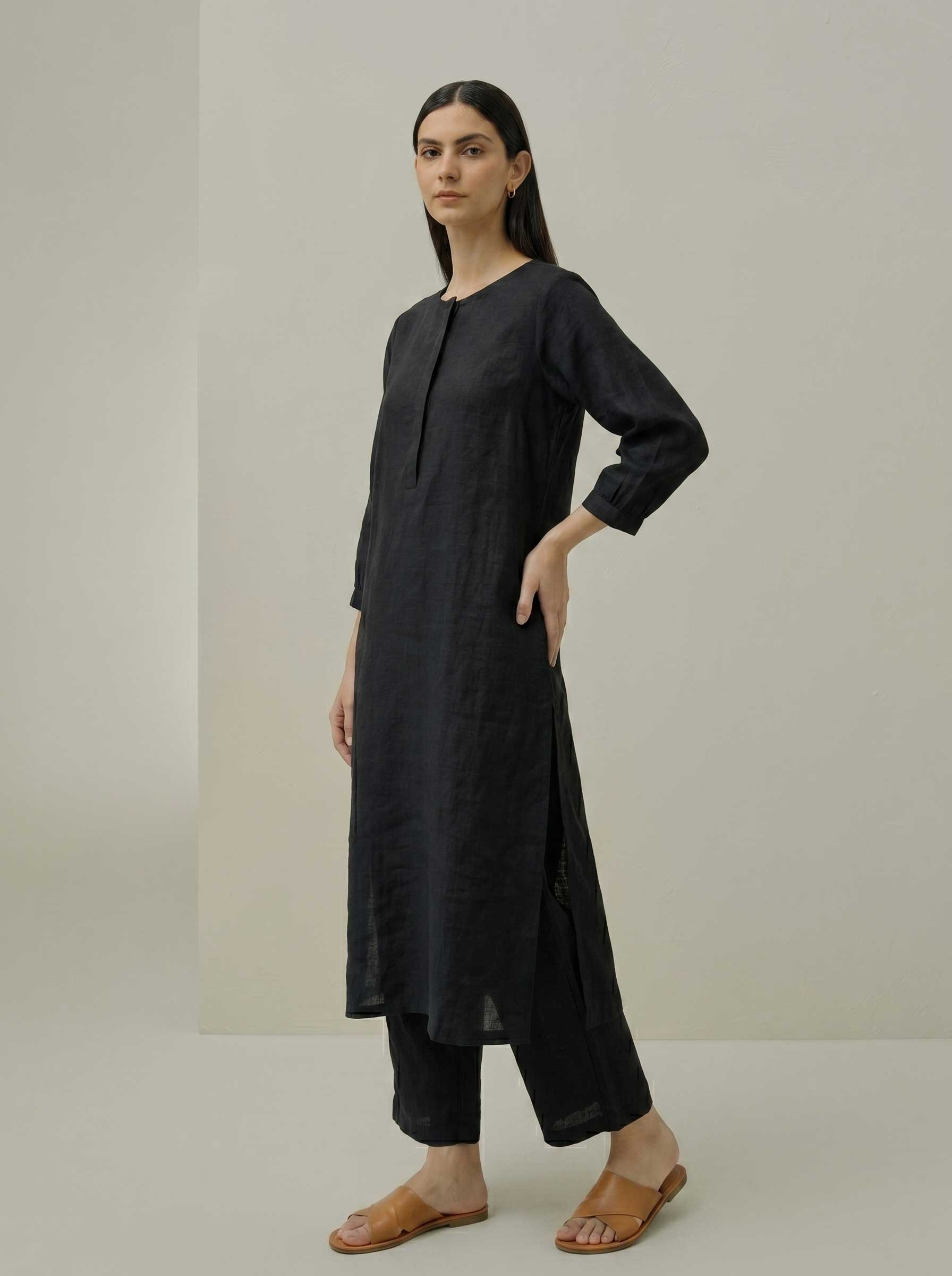 Black pure linen tunic and matching wide-leg pants set, side standing view
