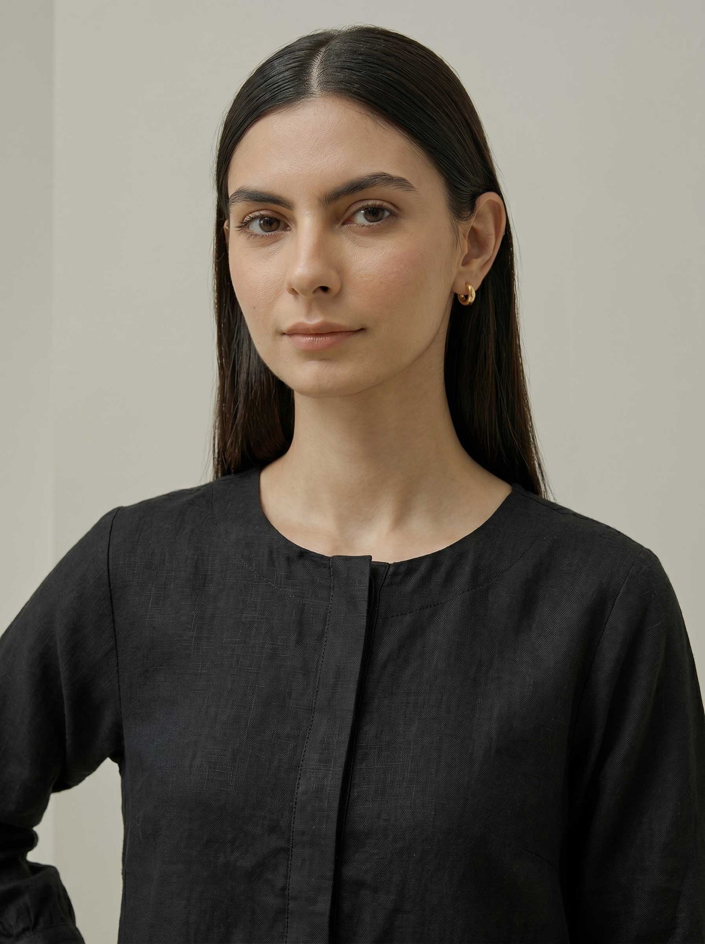 Black pure linen tunic with button placket and round neckline, close-up