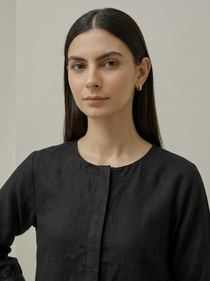 Black pure linen tunic with button placket and round neckline, close-up