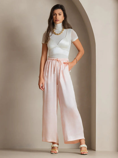 Pink silk relaxed wide-leg pants with elastic waistband and center tie detail
