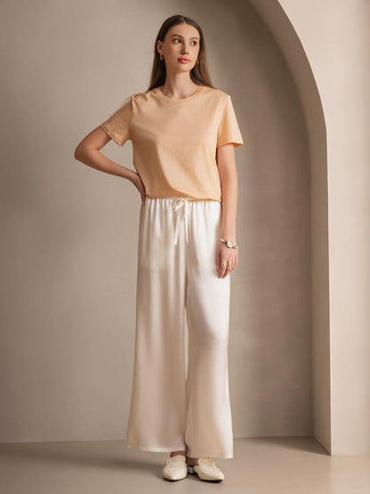 Silk relaxed elastic-waist pants in white, draped wide legs and ribbon-tied waist