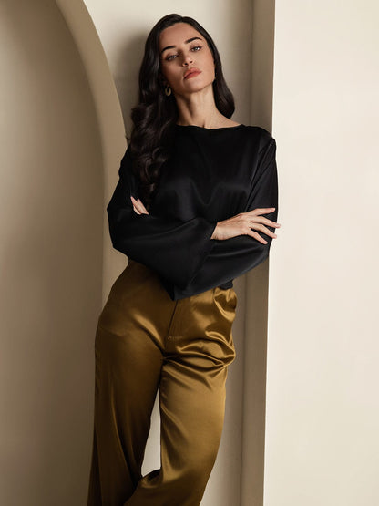 Black satin blouse with wide flare sleeves and round neckline, draped fit.