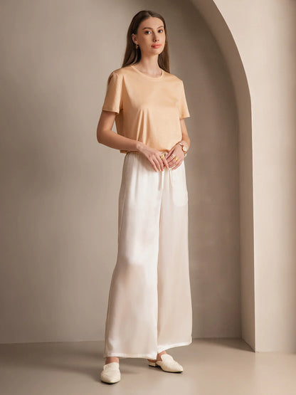 Silk relaxed elastic-waist pants in white with gathered waistband and ribbon ties