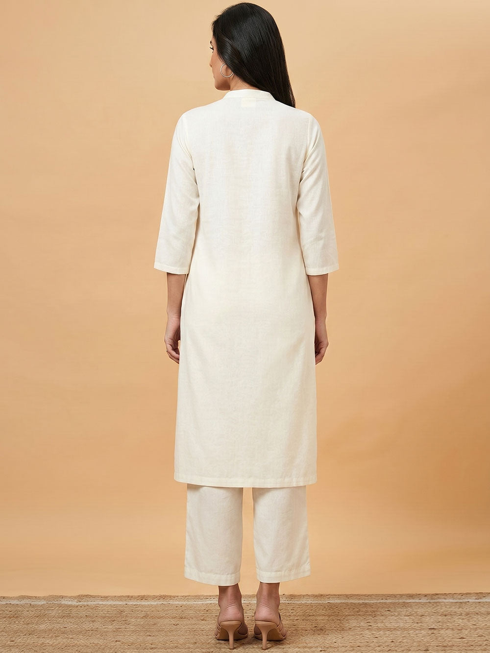 Off-white mandarin-collar long shirt with matching pants, back view